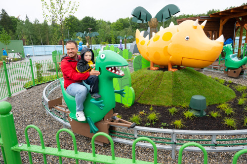 Die Besucher tauchen im neuen PEPPA PIG Park Günzburg ganz in die bunte Welt von Peppa Pig und ihren Freunden ein und können z.B. bei Opi Mümmel auf Schorschs grünem Spielzeug-Dino reiten. 